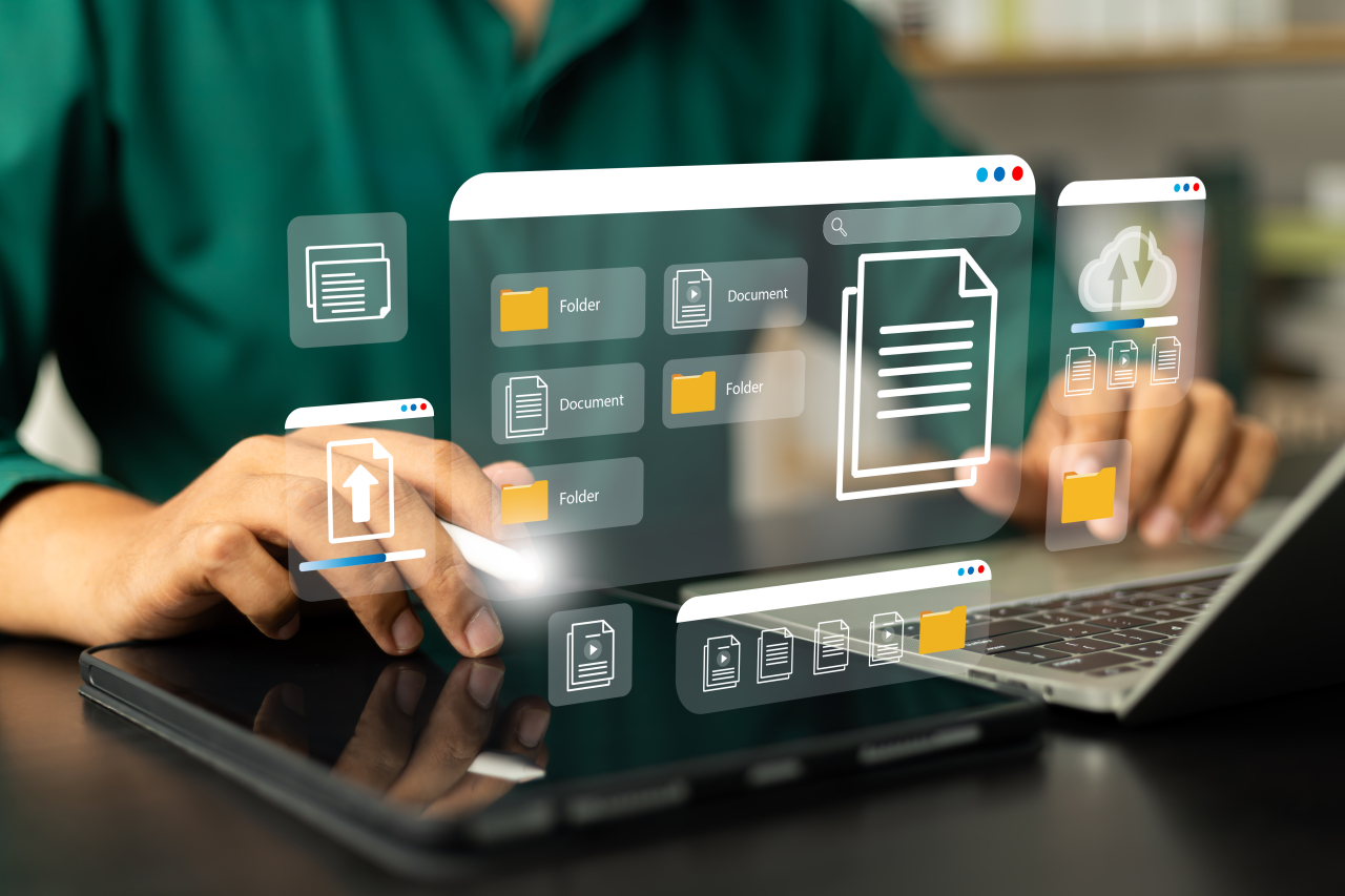 PErson working on a computer with fly out icons.