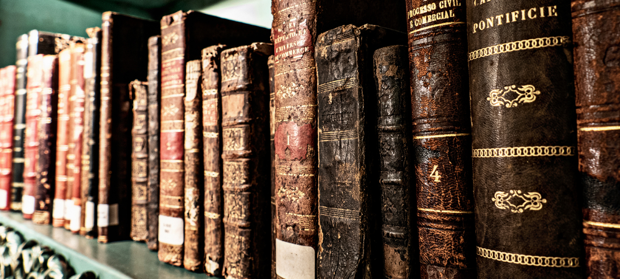 Old books on a book case.