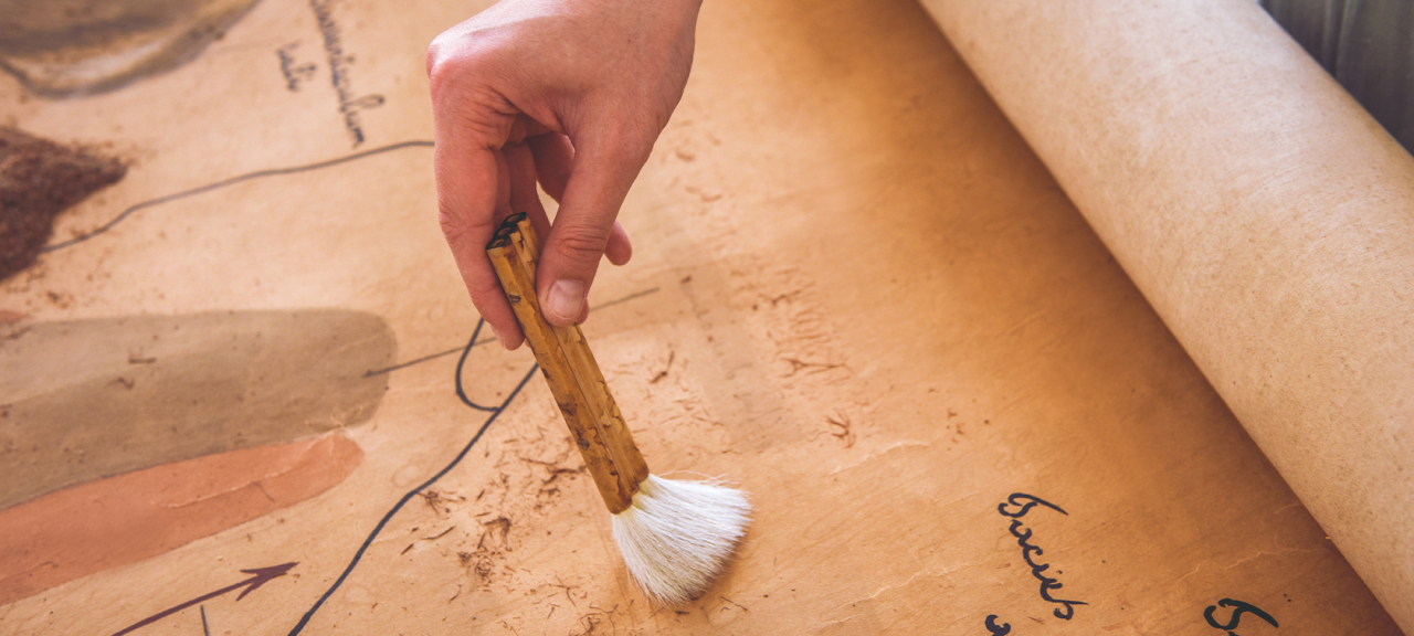 Brush conservation of old scroll.