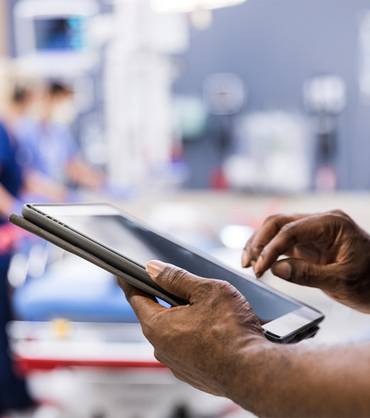 Doctor on an iPad looking at files.