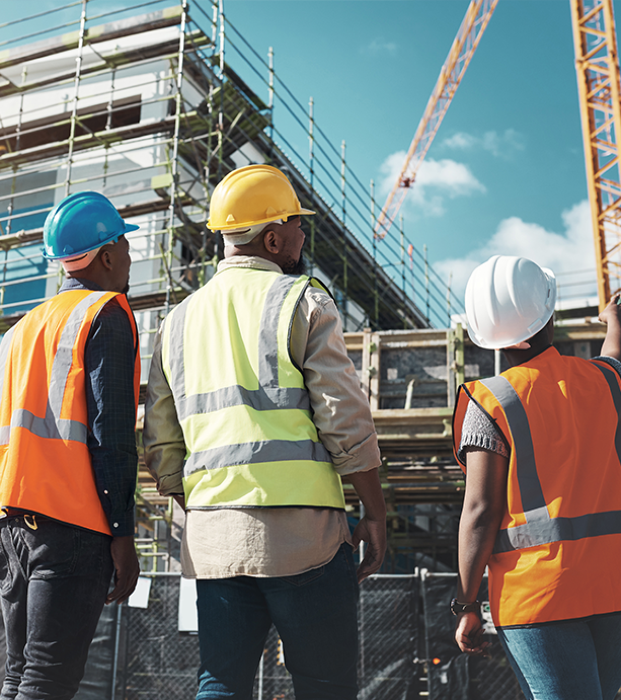 Construction workers looking at building work.