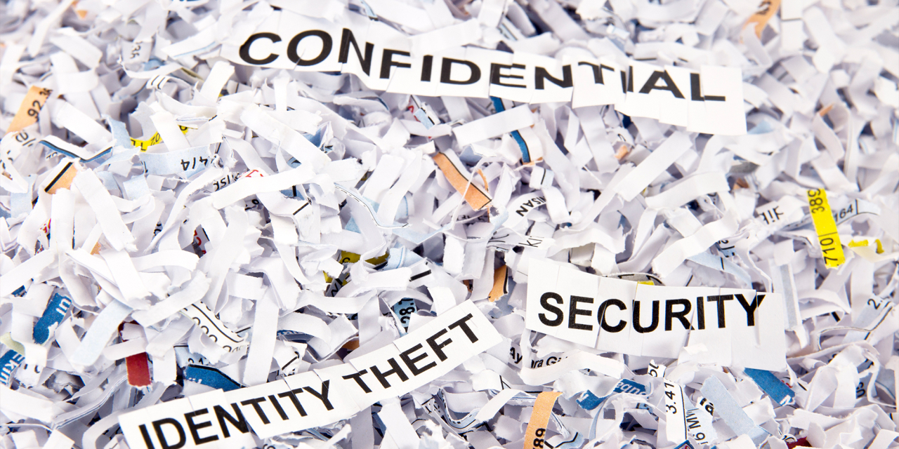 Shredded paper with words Confidential, Security and Identity Theft visible.