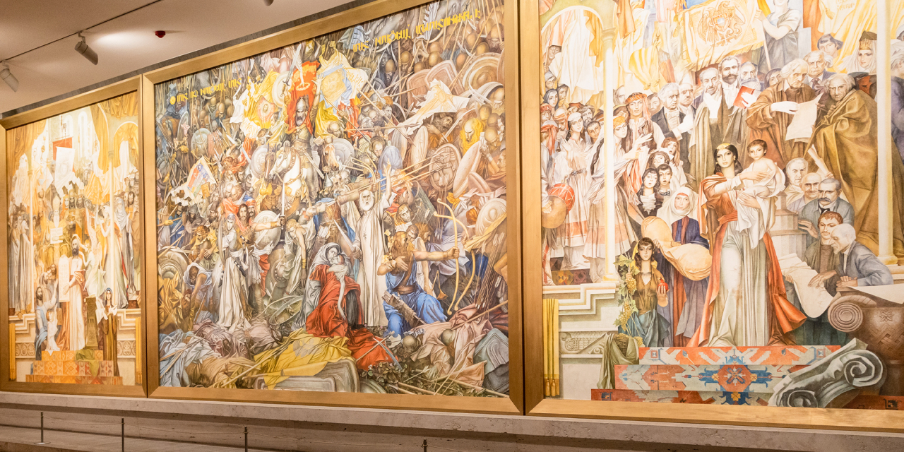 Large painings on a wall in a museum.