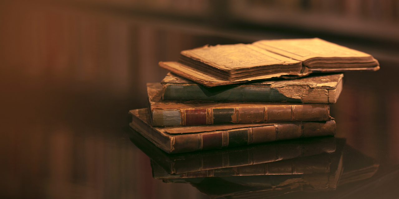 Stack of old books in poor condition.