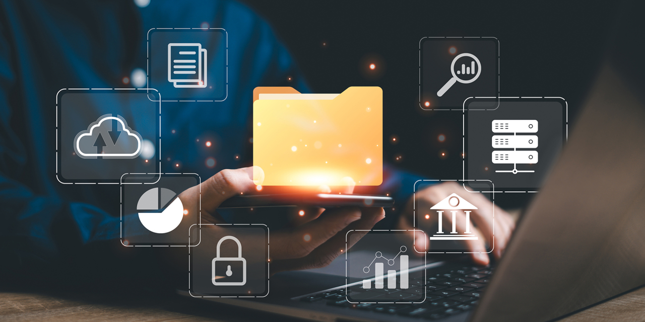 Person working on computer with folder tagged items.