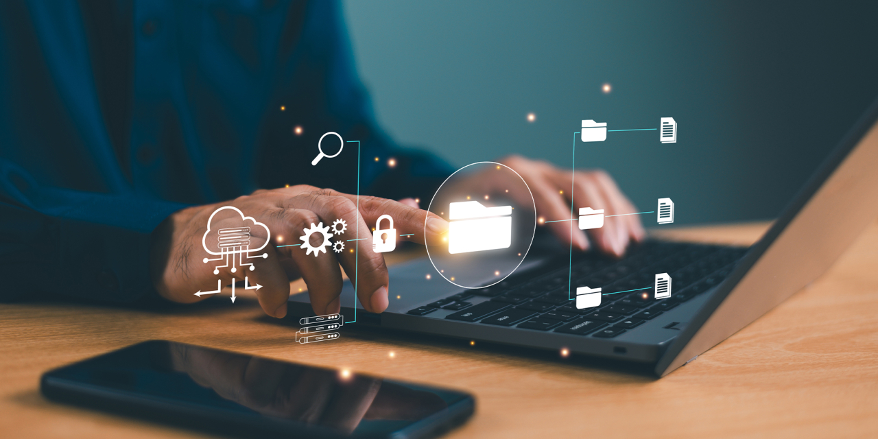 Person working on laptop with digital repository icons.