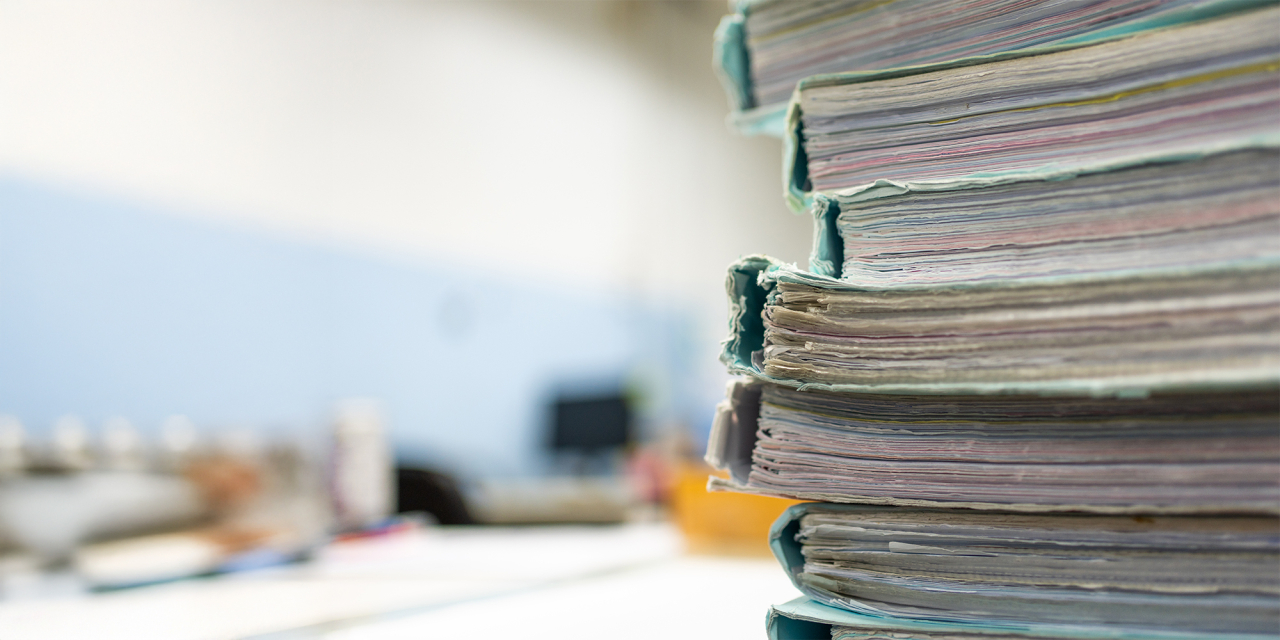 Stack of laboratory notebooks.