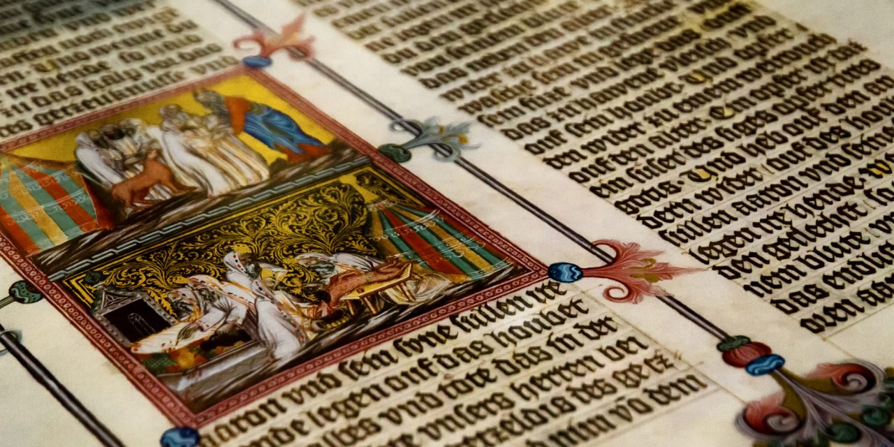Close up of an old manuscript with old text and images.