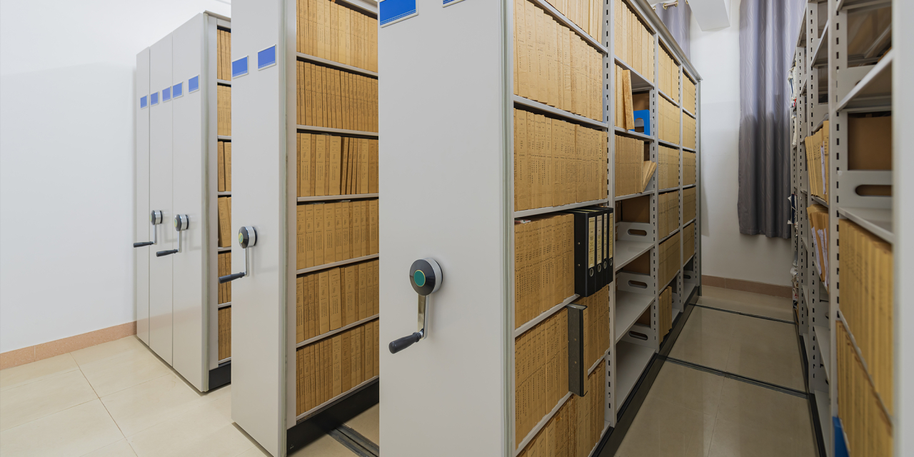 Rows of storage racks with items on.