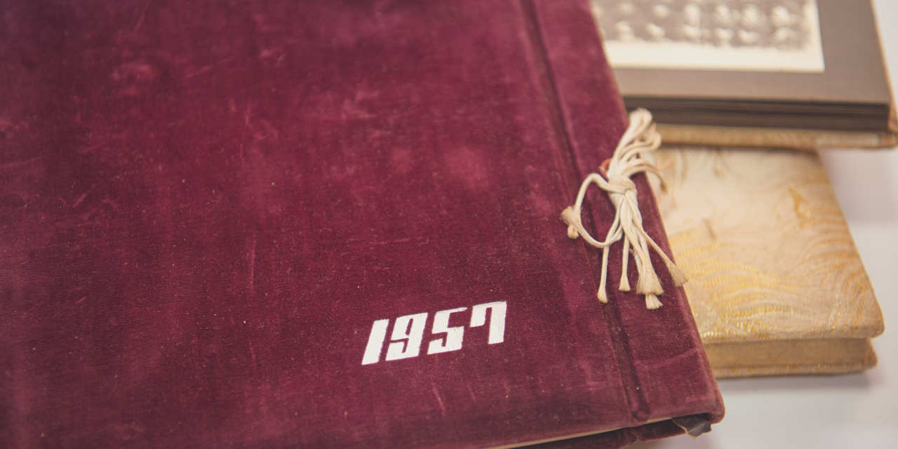 Old photo albums, one with text reading 1957.