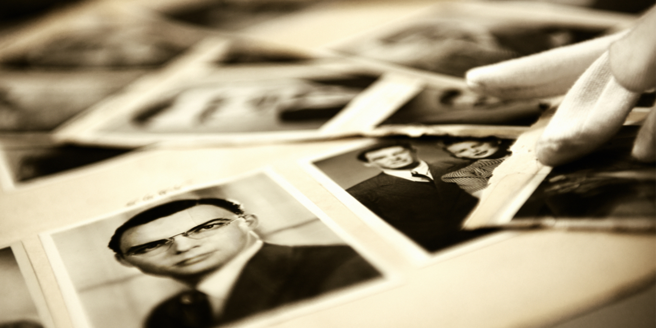 Old black and white photographs in a book.