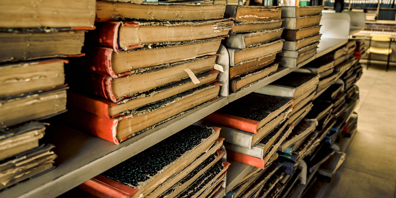 Registers stacked on shelving.