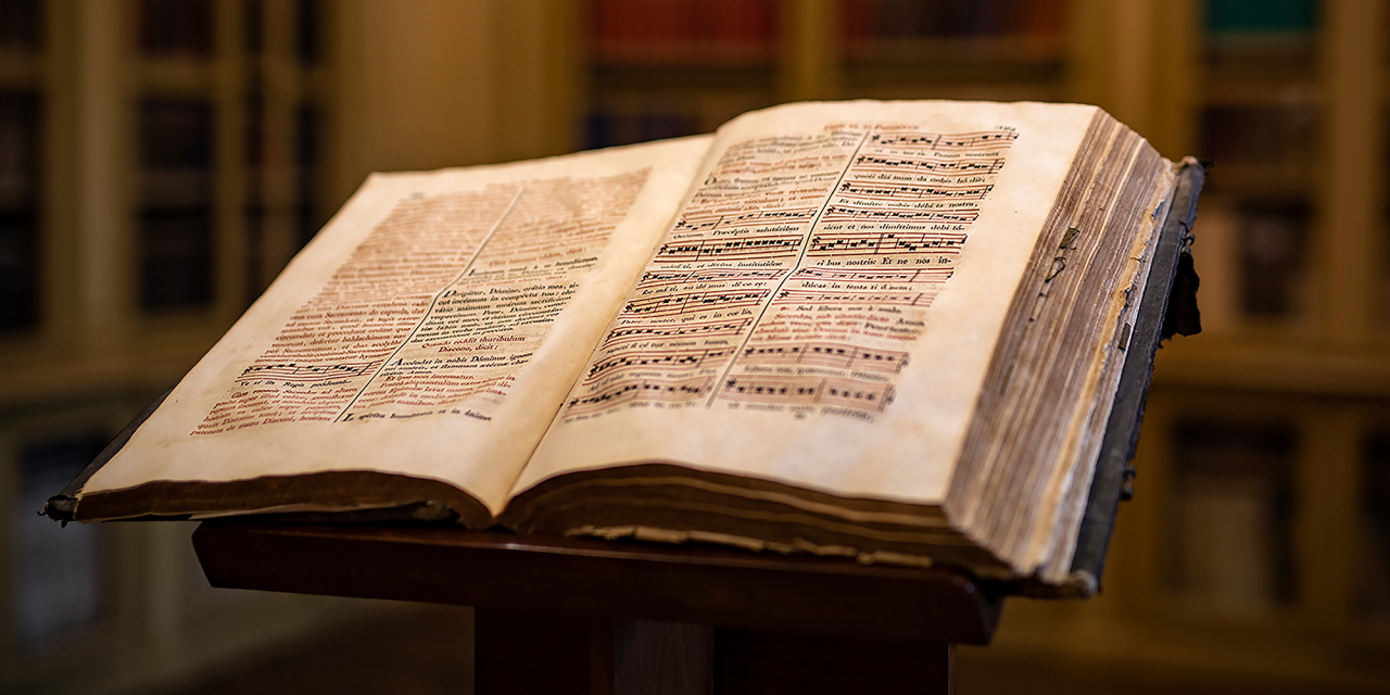 Open book of old music scores.