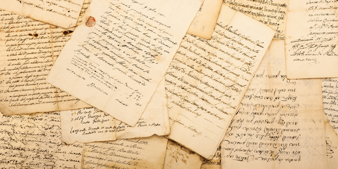 Old historical letters laid on top of each other.