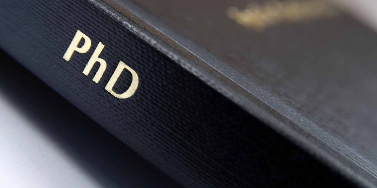 Spine of a book reading PhD.