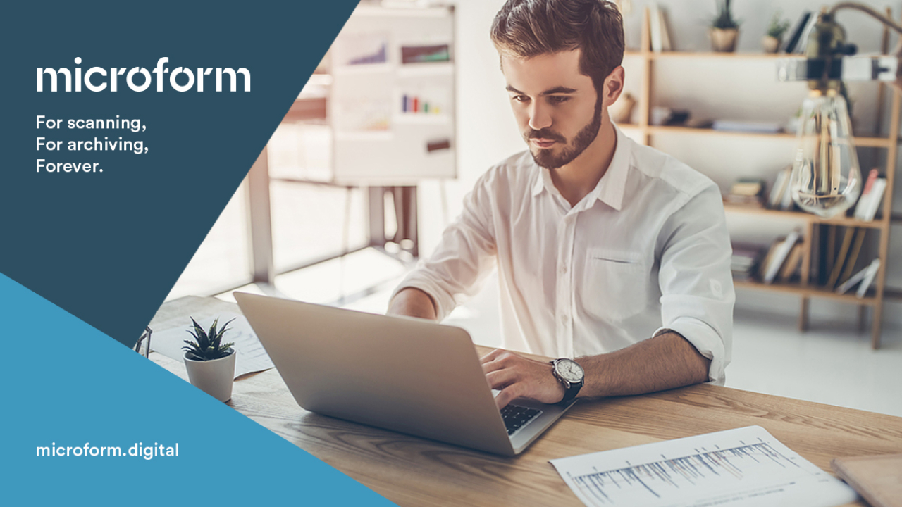 Microform Branding - Man sat in home environment working on a laptop.