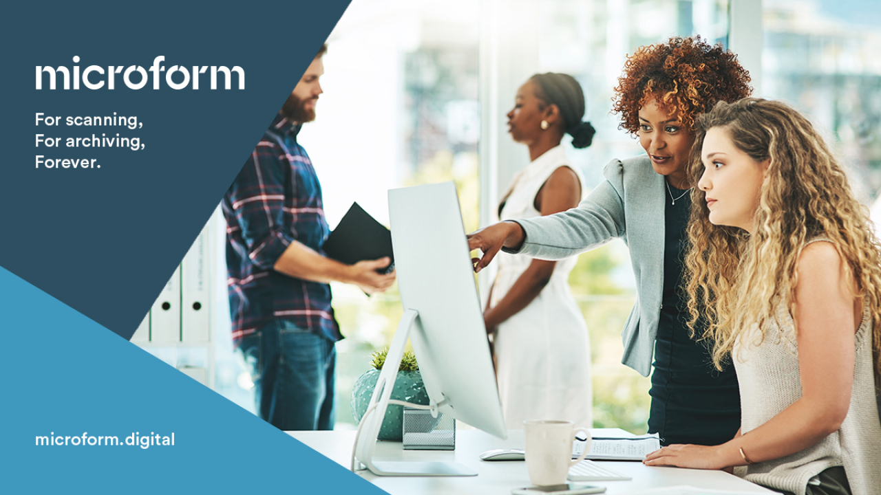 Microform Branding - Colleagues looking at information on a computer screen.