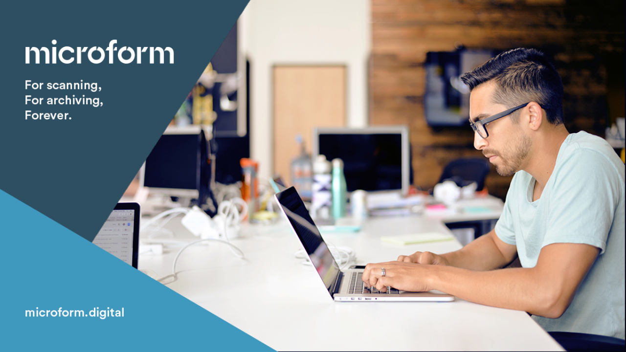 Microform Branding - Person in office environment working on a laptop.