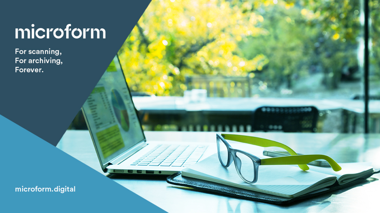 Microform Branding - Laptop and notebook with glasses on top.